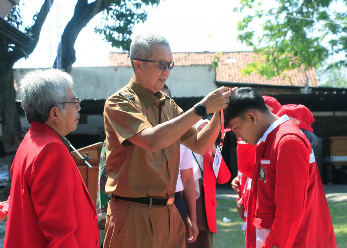 PESERTA: Pj Walikota Agus Mulyadi disaksikan Rektor Untag Guntoro, simbolis mengalungkan tanda peserta KKM Terpadu Untag, Senin (22/7).