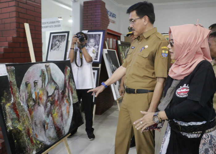 BUDAYA CIREBON: Pj Sekda Iing Daiman mengamati lukisan karya Paguyuban Pelukis Cirebon, dalam Pameran Lukisan Cirebon di DKUKMPP, kemarin.