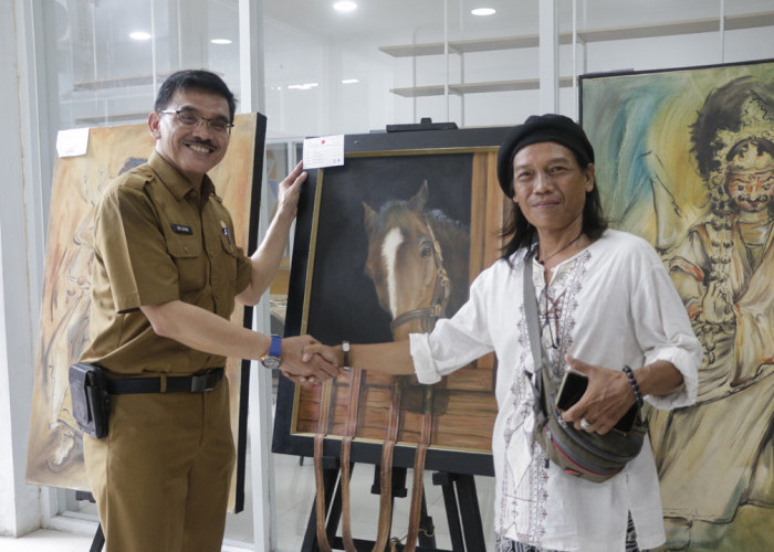 APRESIASI: Pj Sekda Iing Daiman mengapresiasi kegiatan Pameran Lukisan Cirebon, dan membeli salah satu lukisan yang ada di lokasi pameran tersebut.